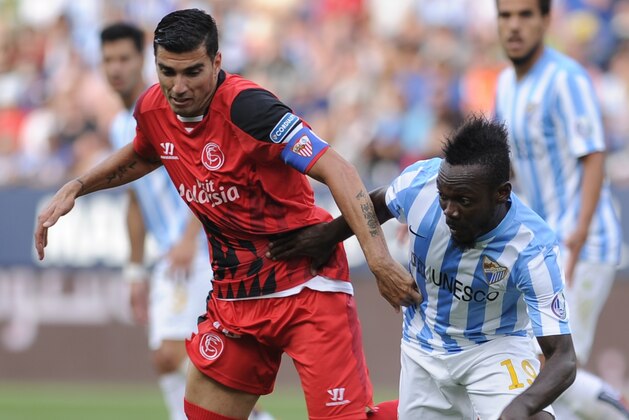 Sevilla's forward Jose Antonio Reyes (L) vies with Malaga's Ivorian defender Arthur Boka (R) during the Spanish league football match Malaga CF vs Sevilla FC at La Rosaleda stadium in Malaga on May 23, 2015.Sevilla won 2-3.    AFP PHOTO / CRISTINA QUICLER        (Photo credit should read CRISTINA QUICLER/AFP/Getty Images)