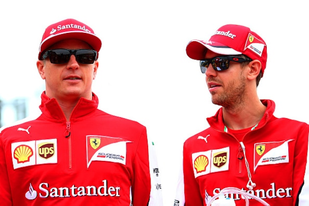 NORTHAMPTON, ENGLAND - JULY 05:  Sebastian Vettel of Germany and Ferrari speaks with Kimi Raikkonen of Finland and Ferrari during the drivers' parade before the Formula One Grand Prix of Great Britain at Silverstone Circuit on July 5, 2015 in Northampton, England.  (Photo by Mark Thompson/Getty Images)