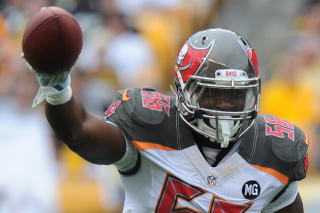 Tampa Bay Buccaneers defensive end Jacquies Smith (56) holds up the ball after recovering a fumble by Pittsburgh Steelers quarterback Ben Roethlisberger (7) in the first quarter of the NFL football game on Sunday, Sept. 28, 2014 in Pittsburgh. (AP Photo/Don Wright)