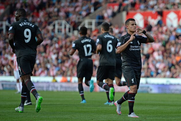 Liverpool's Brazilian midfielder Philippe Coutinho (R) celebrates after scoring the opening goal of the English Premier League football match between Stoke City and Liverpool at the Britannia Stadium in Stoke-on-Trent, central England on August 9, 2015. Liverpool won the game 1-0. AFP PHOTO / OLI SCARFF

RESTRICTED TO EDITORIAL USE. No use with unauthorized audio, video, data, fixture lists, club/league logos or 'live' services. Online in-match use limited to 75 images, no video emulation. No use in betting, games or single club/league/player publications..        (Photo credit should read OLI SCARFF/AFP/Getty Images)