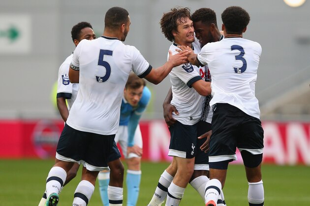 MANCHESTER, ENGLAND - AUGUST 14:  Christian Maghoma of Tottenham Hotspur U21 celebrates with Filip Lesniak after scoring their third goal during the Barclays U21 Premier League match between Manchester City U21 and Tottenham Hotspur U21 at The Academy Stadium on August 14, 2015 in Manchester, England.  (Photo by Alex Livesey/Getty Images)