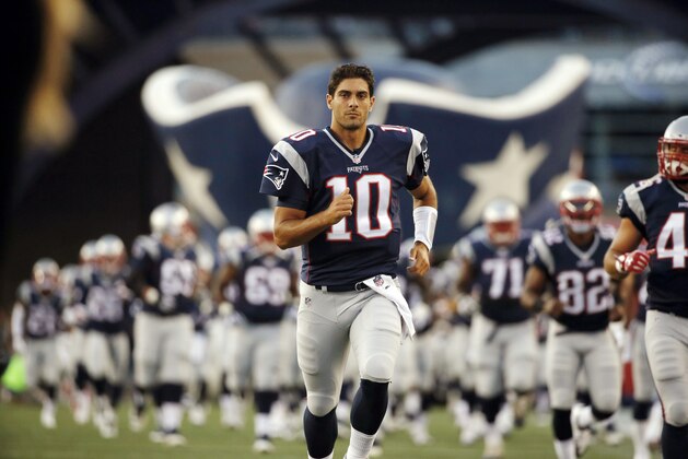 New England Patriots quarterback Jimmy Garoppolo runs onto the field for an NFL preseason football game against the Green Bay Packers Thursday, Aug. 13, 2015, in Foxborough, Mass. (AP Photo/Michael Dwyer)