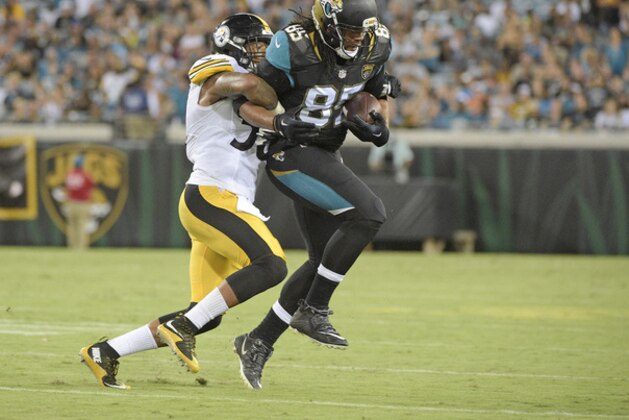 Jacksonville Jaguars tight end Nic Jacobs (85) is stopped after a reception by a Pittsburgh Steelers defender during the first half of an NFL preseason football game, Friday, Aug. 14, 2015, in Jacksonville, Fla. (AP Photo/Phelan M. Ebenhack)