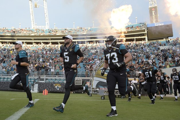 Jacksonville Jaguars quarterback Chad Henne, left, quarterback Blake Bortles (5) and tackle Cody Booth (73) lead the team onto the field during player introductions before an NFL preseason football game against the Pittsburgh Steelers in Jacksonville, Fla., Friday, Aug. 14, 2015. (AP Photo/Phelan M. Ebenhack)