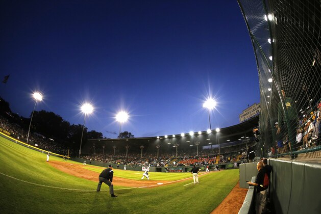 In this photo taken with a fisheye lens, the sky darkens over Lamade Stadium during a baseball game between Pearland and Cumberland in U.S. pool play at the Little League World Series tournament in South Williamsport, Pa., Friday, Aug. 15, 2014. Pearland won 6-4. (AP Photo/Gene J. Puskar)