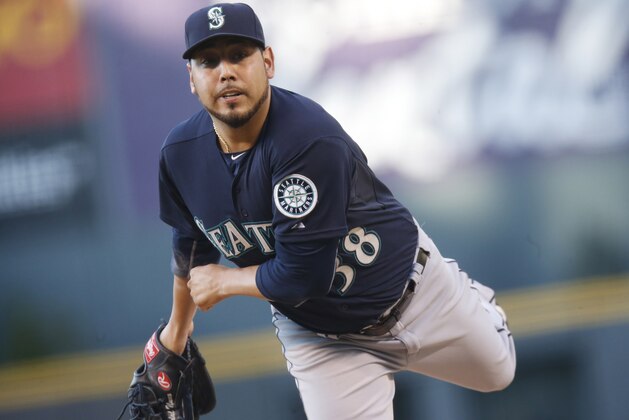 Seattle Mariners starting pitcher Vidal Nuno works against the Colorado Rockies  in the first inning of an inter league baseball game Tuesday, Aug. 4, 2015, in Denver. (AP Photo/David Zalubowski)