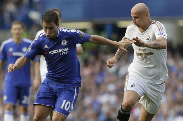 Chelsea’s Eden Hazard, left, competes for the ball with Swansea’s Jonjo Shelvey during the English Premier League soccer match between Chelsea and Swansea City at Stamford Bridge, London, Saturday Aug. 8, 2015. (AP Photo/Tim Ireland)