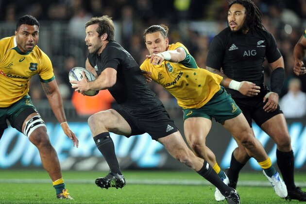 New Zealand’s Conrad Smith slips the tackle of Australia’s Matt Toomua during their Bledisloe Cup rugby match in Auckland, New Zealand, Saturday, August 15, 2015. (Ross Setford/SNPA via AP) NEW ZEALAND OUT
