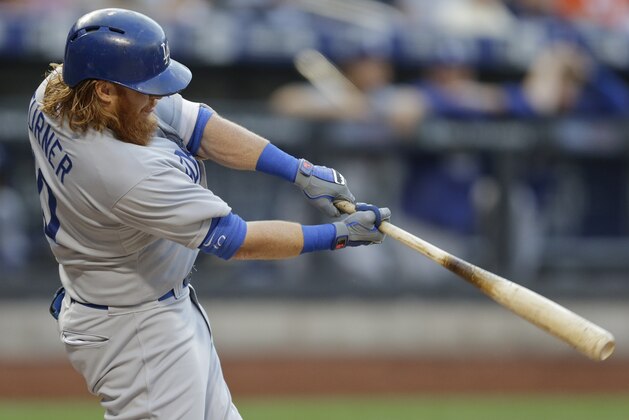 Los Angeles Dodgers' Justin Turner hits an hits an RBI double during the first inning of a baseball game against the New York Mets on Friday, July 24, 2015, in New York. (AP Photo/Frank Franklin II)