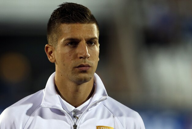 Serbia's Matija Nastasic stands during the playing of his country's national anthem before the start of their international friendly soccer match against France, in Belgrade, Serbia, Sunday, Sept. 7, 2014. (AP Photo/Darko Vojinovic)