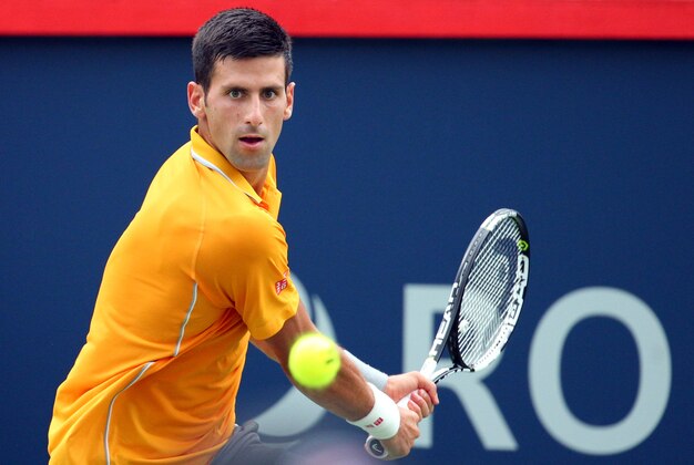 Aug 15, 2015; Montreal, Quebec, Canada; Novak Djokovic of Serbia hits a shot against Jeremy Chardy of France (not pictured) during the Rogers Cup tennis tournament at Uniprix Stadium. Mandatory Credit: Jean-Yves Ahern-USA TODAY Sports