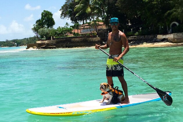 Lewis Hamilton paddle boarding on his summer vacation.