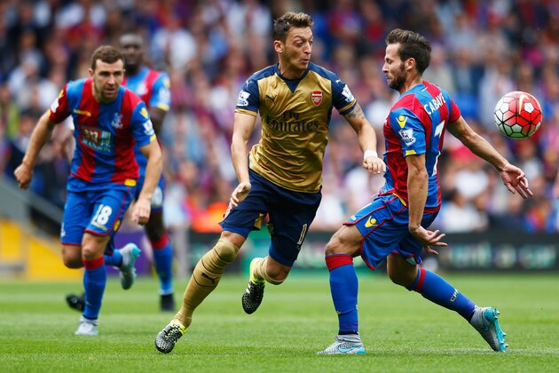 LONDON, ENGLAND - AUGUST 16: Mesut Oezil of Arsenal is challenged by Yohan Cabaye of Crystal Palace during the Barclays Premier League match between Crystal Palace and Arsenal at Selhurst Park on August 16, 2015 in London, England.  (Photo by Julian Finney/Getty Images)
