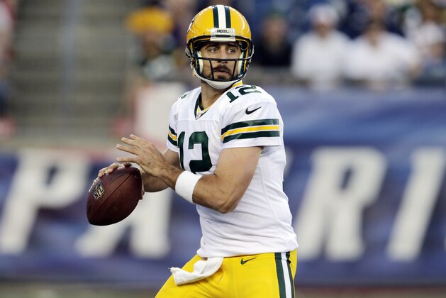 Green Bay Packers quarterback Aaron Rodgers looks for a receiver in the first half of an NFL preseason football game against the New England Patriots Thursday, Aug. 13, 2015, in Foxborough, Mass. (AP Photo/Charles Krupa)