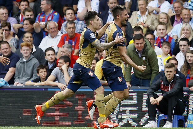 Arsenal's Olivier Giroud, right, celebrates scoring a goal with Hector Bellerini during the English Premier League soccer match between Arsenal and Crystal Palace at Selhurst Park Stadium in London, Sunday, Aug. 16, 2015. (AP Photo/Kirsty Wigglesworth)