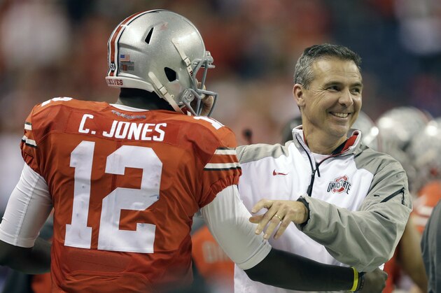 Ohio State head coach Urban Meyer, right, smiles along side quarterback Cardale Jones during the second half of the Big Ten Conference championship NCAA college football game against Wisconsin Saturday, Dec. 6, 2014, in Indianapolis. (AP Photo/Darron Cummings)