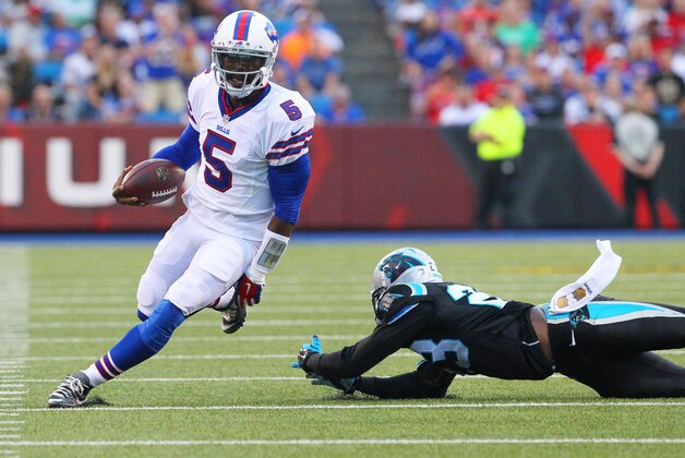 Buffalo Bills quarterback Tyrod Taylor (5) runs against Carolina Panthers cornerback Melvin White (23) during the first half of an NFL preseason football game on Friday, Aug. 14, 2015, in Orchard Park, N.Y. (AP Photo/Bill Wippert)