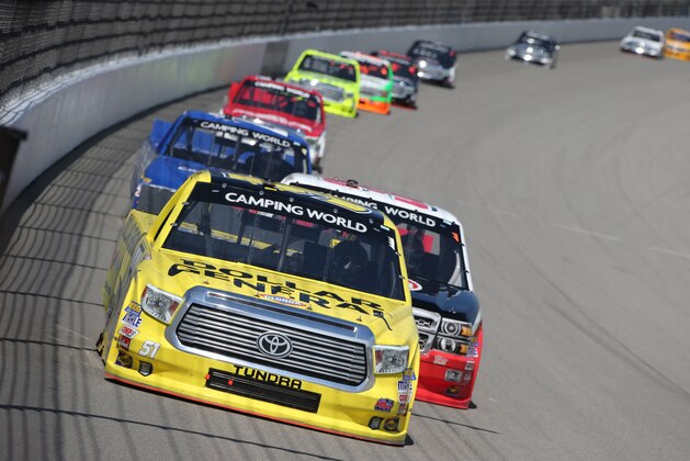Kyle Busch leads through the first turn during the NASCAR Truck series Careers for Veterans 200 race at Michigan International Speedway, Saturday, Aug. 15, 2015, in Brooklyn, Mich. (AP Photo/Bob Brodbeck)