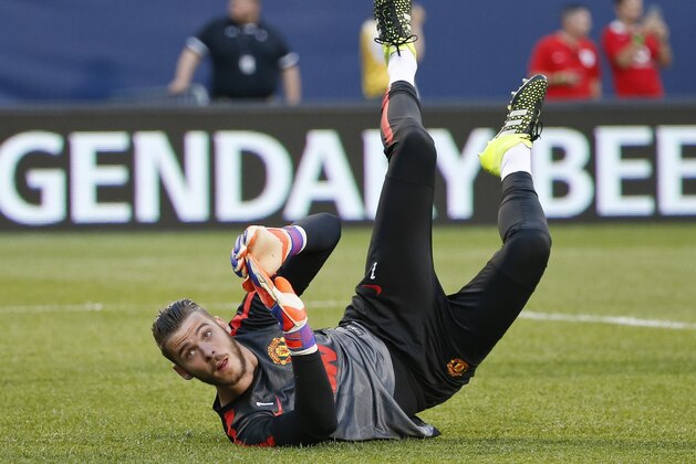 Manchester United goalkeeper David De Gea warms up before an International Champions Cup soccer match against Paris Saint-Germain on Wednesday, July 29, 2015, in Chicago. (AP Photo/Kamil Krzaczynski)