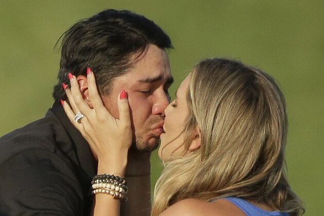 Jason Day, of Australia, kisses his wife Ellie Harvey after winning the PGA Championship golf tournament Sunday, Aug. 16, 2015, at Whistling Straits in Haven, Wis. (AP Photo/Chris Carlson)