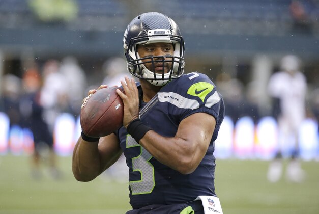Seattle Seahawks quarterback Russell Wilson passes during warmups before a preseason NFL football game against the Denver Broncos, Friday, Aug. 14, 2015, in Seattle. (AP Photo/Elaine Thompson)