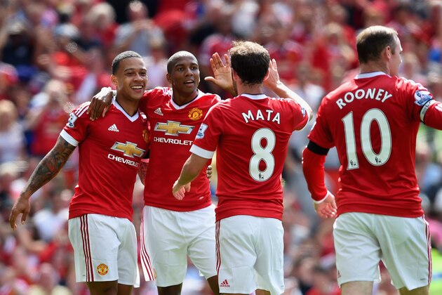 MANCHESTER, ENGLAND - AUGUST 08: (L to R) Memphis Depay, Ashley Young, Juan Mata and Wayne Rooney of Manchester United celebrate their team's first goal during the Barclays Premier League match between Manchester United and Tottenham Hotspur at Old Trafford on August 8, 2015 in Manchester, England.  (Photo by Michael Regan/Getty Images)