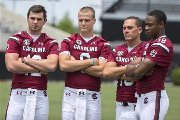 From left to right,  South Carolina quarterbacks Michael Scarnecchia (12), Connor Mitch (6), Perry Orth (10) and Lorenzo Nunez (19) pose for a photograph during NCAA college football media day in Columbia, S.C., Sunday, Aug. 9, 2015. (AP Photo/Stephen B. Morton)