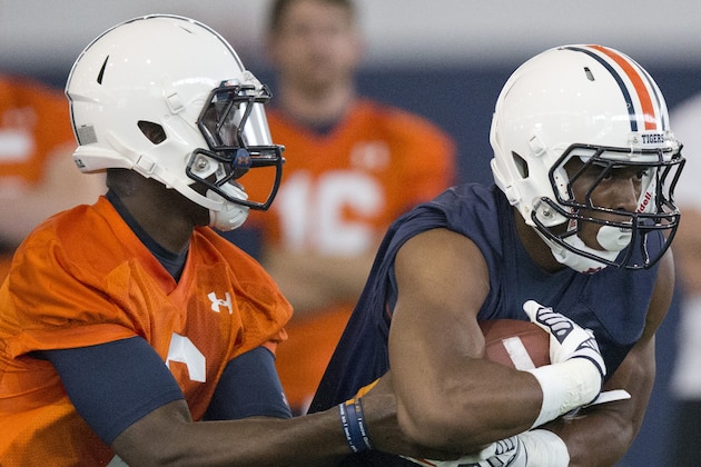 Auburn quarterback Jeremy Johnson (6) hands off to running back Roc Thomas (9) during an NCAA college football practice, Tuesday, Aug. 4, 2015, in Auburn, Ala. (AP Photo/Brynn Anderson)