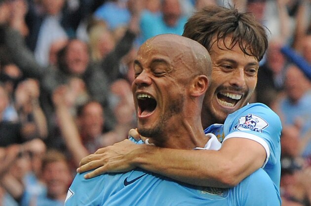 Manchester City’s Vincent Kompany, front and Manchester City’s David Silva during the English Premier League soccer match between Manchester City and Chelsea at Etihad stadium, Manchester, England, Sunday, Aug. 16, 2015. (AP Photo/Rui Vieira