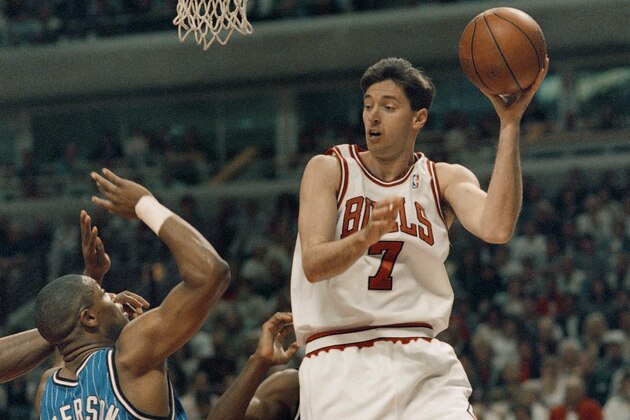 The Chicago Bulls' Toni Kukoc looks to pass off around Orlando Magic's Nick Anderson during the first quarter of their second-round Playoff Game in Chicago, Sunday, May 14, 1994. The Bulls beat the Magic 106-95 to even the series at two games apiece. (AP Photo/Fred Jewell)