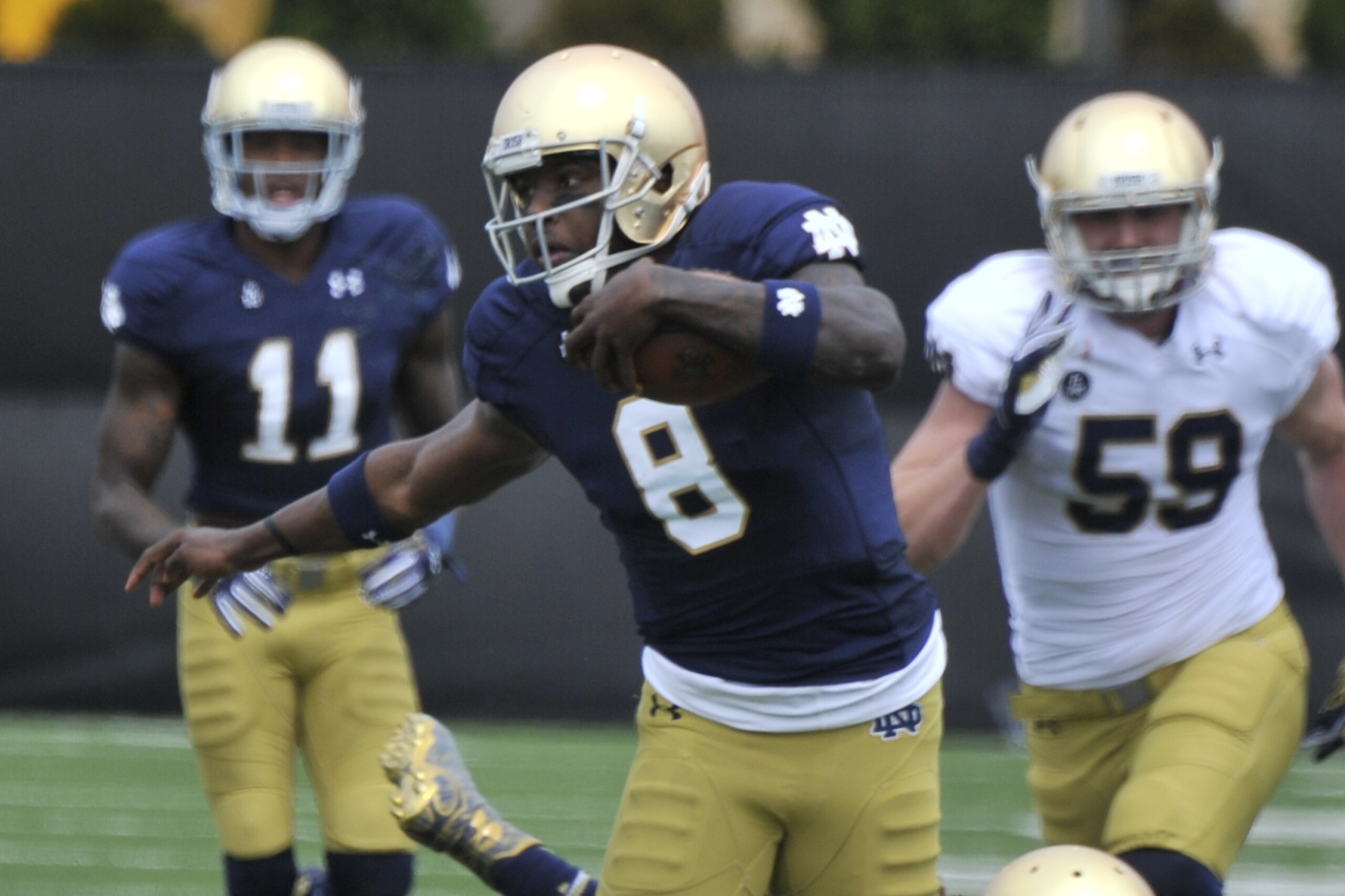 Notre Dame quarterback Malik Zaire (8) heads up field during the Blue Gold game Saturday April 18, 2015 in South Bend, Ind. (AP Photo/Joe Raymond)