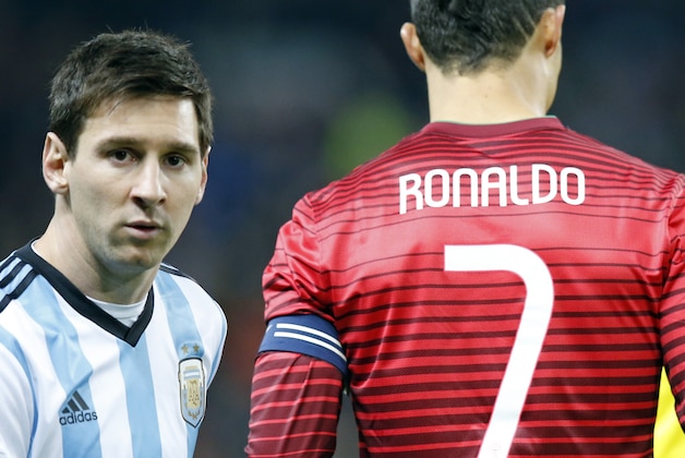 Lionel Messi of Argentina, left, stands next to Cristiano Ronaldo of Portugal before their International Friendly soccer match at Old Trafford Stadium, Manchester, England, Tuesday Nov. 18, 2014. (AP Photo/Jon Super)