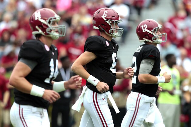 Alabama quarterbacks Jacob Coker (14), Blake Barnett (6), and David Cornwell (12) run across the field during warmups before the first half of Alabama's spring NCAA college football game Saturday, April 18, 2015, in Tuscaloosa, Ala. (AP Photo/Butch Dill)