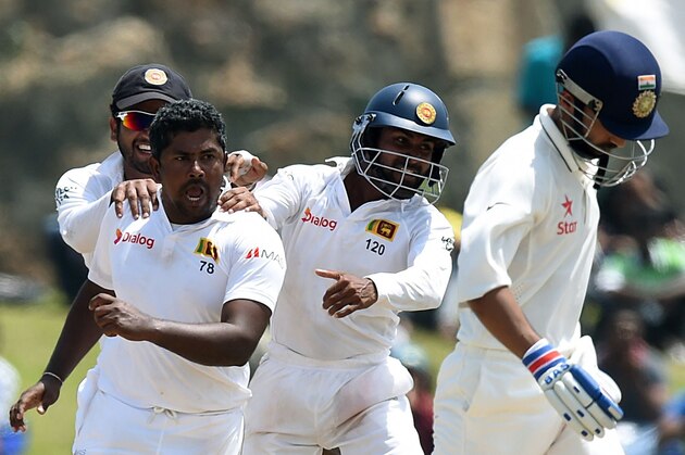 Sri Lankan cricketer Rangana Herath (2L) and teammates celebrate after dismissing Indian batsman Ajinkya Rahane (R) during the fourth day of the opening Test match between Sri Lanka and India at the Galle International Cricket Stadium in Galle on August 15, 2015. AFP PHOTO/ Ishara S. KODIKARA        (Photo credit should read Ishara S.KODIKARA/AFP/Getty Images)