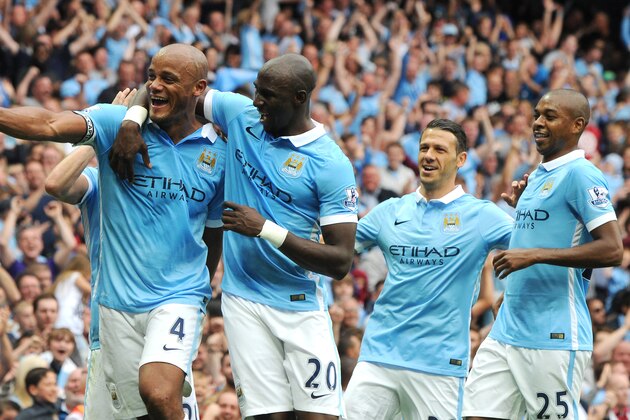 Manchester City’s Vincent Kompany, left, celebrates with teammates after scoring against Chelsea during the English Premier League soccer match between Manchester City and Chelsea at Etihad stadium, Manchester, England, Sunday, Aug. 16, 2015. (AP Photo/Rui Vieira)