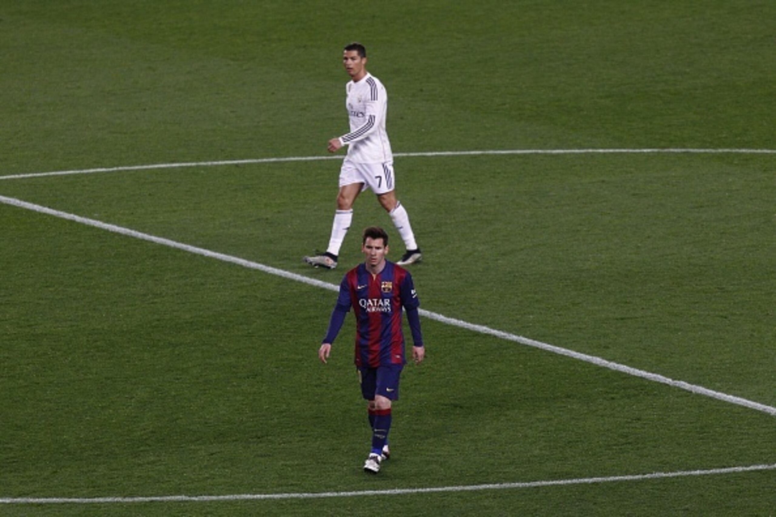 Barcelona's Argentinian forward Lionel Messi (DOWN)  and Real Madrid's Portuguese forward Cristiano Ronaldo walk on the field during the 'clasico' Spanish league football match FC Barcelona vs Real Madrid CF at the Camp Nou stadium in Barcelona on March 22, 2015. AFP PHOTO / QUIQUE GARCIA        (Photo credit should read QUIQUE GARCIA/AFP/Getty Images)
