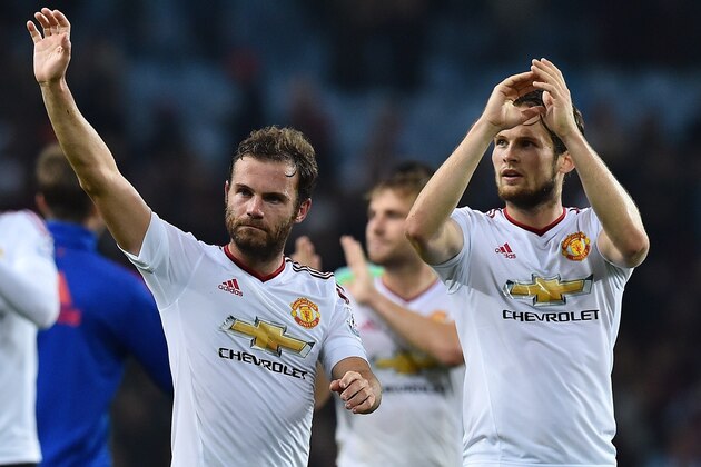 Manchester United's Spanish midfielder Juan Mata (L) and Manchester United's Dutch midfielder Daley Blind applaud the fans after their 1-0 victory in the English Premier League football match between Aston Villa and Manchester United at Villa Park in Birmingham, central England, on August 14, 2015. AFP PHOTO / BEN STANSALL

RESTRICTED TO EDITORIAL USE. No use with unauthorized audio, video, data, fixture lists, club/league logos or 'live' services. Online in-match use limited to 75 images, no video emulation. No use in betting, games or single club/league/player publications.        (Photo credit should read BEN STANSALL/AFP/Getty Images)