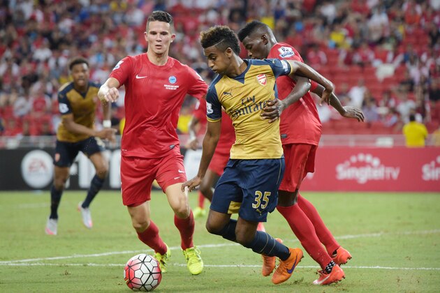 Arsenal midfielder Gedion Zelalem, center, is challenged by Singapore Selection's Sirina Camara, right, in the Barclays Asia Trophy soccer match in Singapore, Wednesday, July 15, 2015. (AP Photo/Joseph Nair)