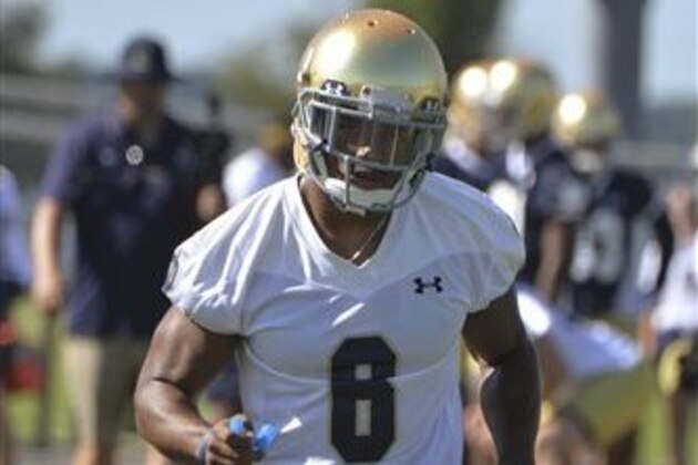 In this Friday, Aug. 7, 2015, photo, Notre Dame cornerback KeiVarae Russell loosens up up during the first practice of the season for the NCAA college football team in Culver, Ind. Russell is more worried about learning to trust his instincts again than knocking off rust as he returns to the football field after a season-long banishment. (AP Photo/Joe Raymond)