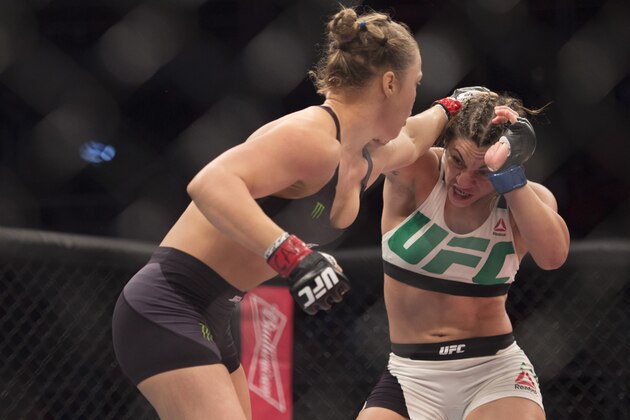 RIO DE JANEIRO, BRAZIL - AUGUST 01:  (L-R) UFC women's bantamweight champion Ronda Rousey punches Bethe Correia of Brazil during the UFC 190 event inside HSBC Arena on August 1, 2015 in Rio de Janeiro, Brazil.  (Photo by Jeff Bottari/Zuffa LLC/Zuffa LLC via Getty Images)