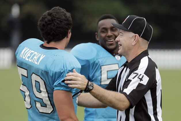 Carolina Panthers' Thomas Davis (58) and Luke Kuechly (59) joke with referee Derek Bowers (74) during the NFL football team's training camp in Spartanburg, S.C., Thursday, Aug. 6, 2015. (AP Photo/Chuck Burton)