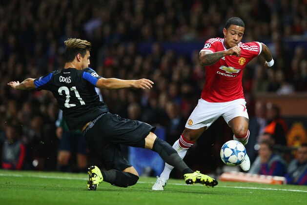MANCHESTER, ENGLAND - AUGUST 18:  Memphis Depay of Manchester United goes past Dion Cools of Club Brugge during the UEFA Champions League Qualifying Round Play Off First Leg match between Manchester United and Club Brugge at Old Trafford on August 18, 2015 in Manchester, England.  (Photo by Alex Livesey/Getty Images)