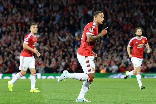 Manchester United's Dutch midfielder Memphis Depay (C) celebrates after scoring his team's second goal during the UEFA Champions League play off football match between Manchester United and Club Brugge at Old Trafford in Manchester, north west England, on August 18, 2015. AFP PHOTO / OLI SCARFF        (Photo credit should read OLI SCARFF/AFP/Getty Images)