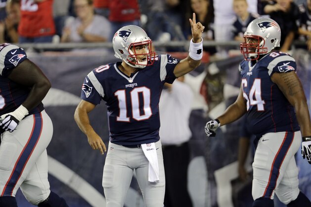 New England Patriots quarterback Jimmy Garoppolo (10) signals his team to go for a two-point conversion after a touchdown in the first half of an NFL preseason football game against the Green Bay Packers Thursday, Aug. 13, 2015, in Foxborough, Mass. (AP Photo/Charles Krupa)