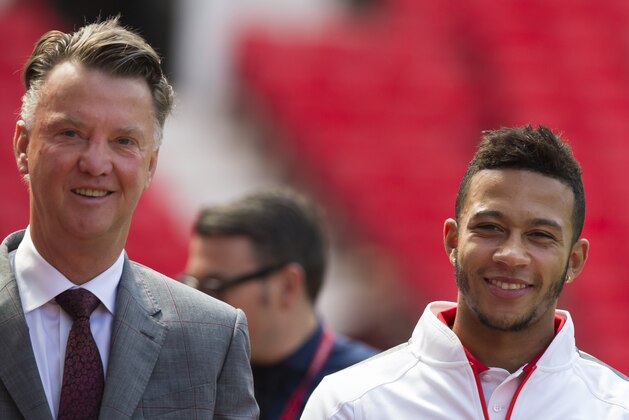Manchester United's new player Memphis Depay, right, smiles as he walks alongside manager Louis van Gaal before posing for photographs at Old Trafford Stadium, Manchester, England, Friday July 10, 2015. The 21 year old Dutch international joined his Manchester United team-mates for the first time since his £25million move from PSV Eindhoven. (AP Photo/Jon Super)