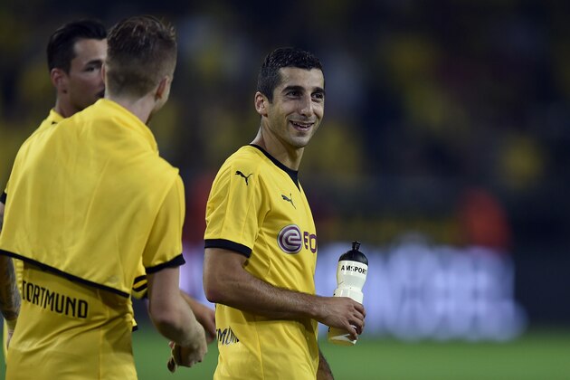 Dortmund's Henrikh Mkhitaryan from Armenia, right, smiles after scoring a hat-trick during the Europa League qualifying soccer match between Borussia Dortmund and Wolfsberger AC in Dortmund, Germany, Thursday, Aug. 6, 2015. Dortmund defeated Wolfsberg with 5-0.  (AP Photo/Martin Meissner)