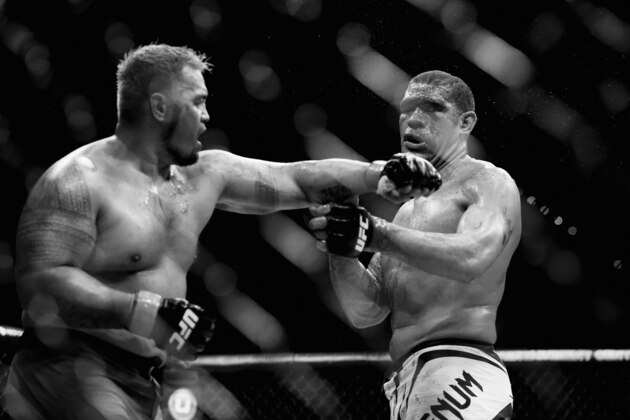 BRISBANE, AUSTRALIA - DECEMBER 07:  (This digital image has been converted to black & white) Mark Hunt punches Antonio 'Bigfoot' Silva in their heavyweight fight during the UFC Fight Night event at the Brisbane Entertainment Centre on December 7, 2013 in Brisbane, Australia.  (Photo by Chris Hyde/Getty Images)