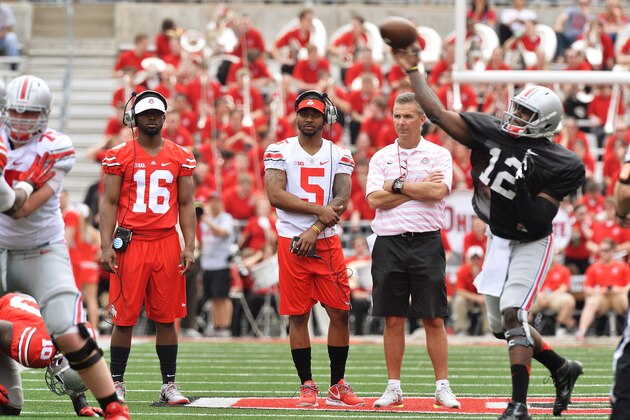 COLUMBUS, OH - APRIL 18:  Quarterbacks J.T. Barrett #16 of the Ohio State Buckeyes and Braxton Miller #5 of the Ohio State Buckeyes watch alongside Head Coach Urban Meyer of the Ohio State Buckeyes as Cardale Jones #12 of the Ohio State Buckeyes runs the offense for the Ohio State Buckeyes Gray team against the Scarlet team at Ohio Stadium on April 18, 2015 in Columbus, Ohio.  (Photo by Jamie Sabau/Getty Images)