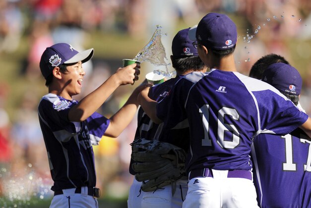 Aug 24, 2014; South Williamsport, PA, USA; Asia-Pacific Region players celebrate after beating the Great Lakes Region 8-4 at Howard J. Lamade Stadium. Mandatory Credit: Evan Habeeb-USA TODAY Sports