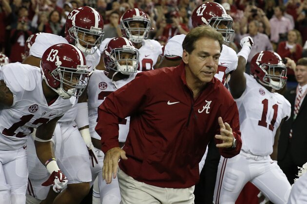 Alabama head coach Nick Saban takes the field with his team before the first half of the Southeastern Conference championship NCAA college football game against Missouri, Saturday, Dec. 6, 2014, in Atlanta. (AP Photo/Brynn Anderson)